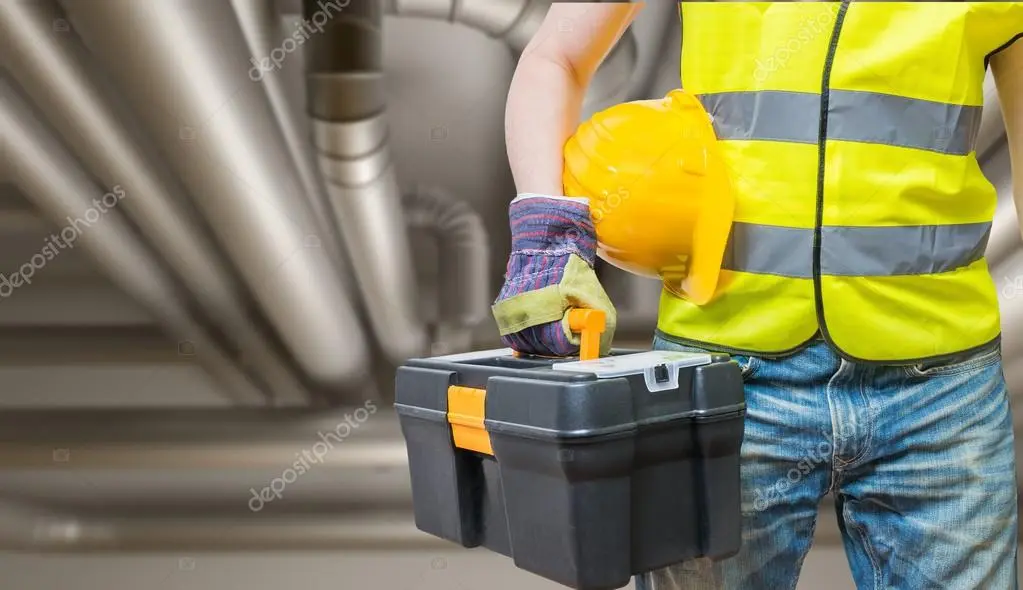 Technician inspecting ductwork in an attic