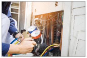 Technician servicing HVAC and electrical systems