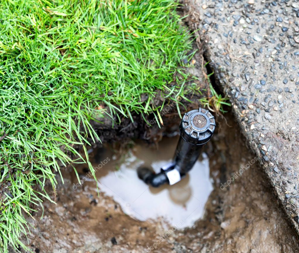 Technician repairing a lawn sprinkler valve