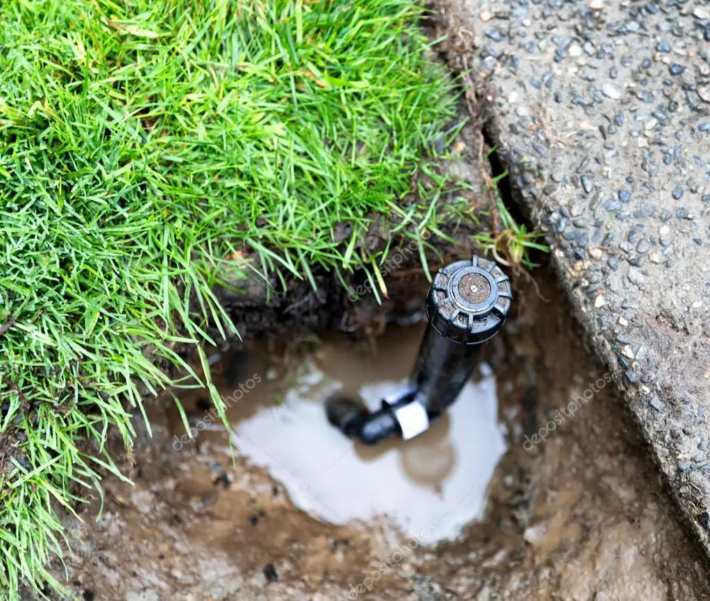 Technician repairing a lawn sprinkler valve