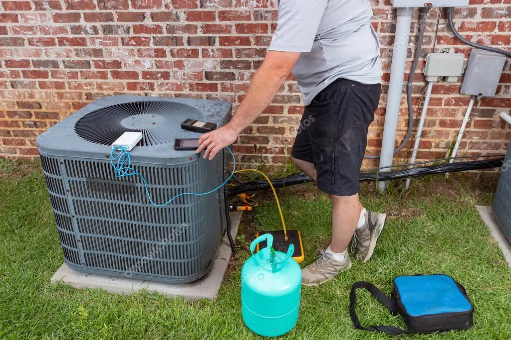 HVAC technician checking an AC condenser