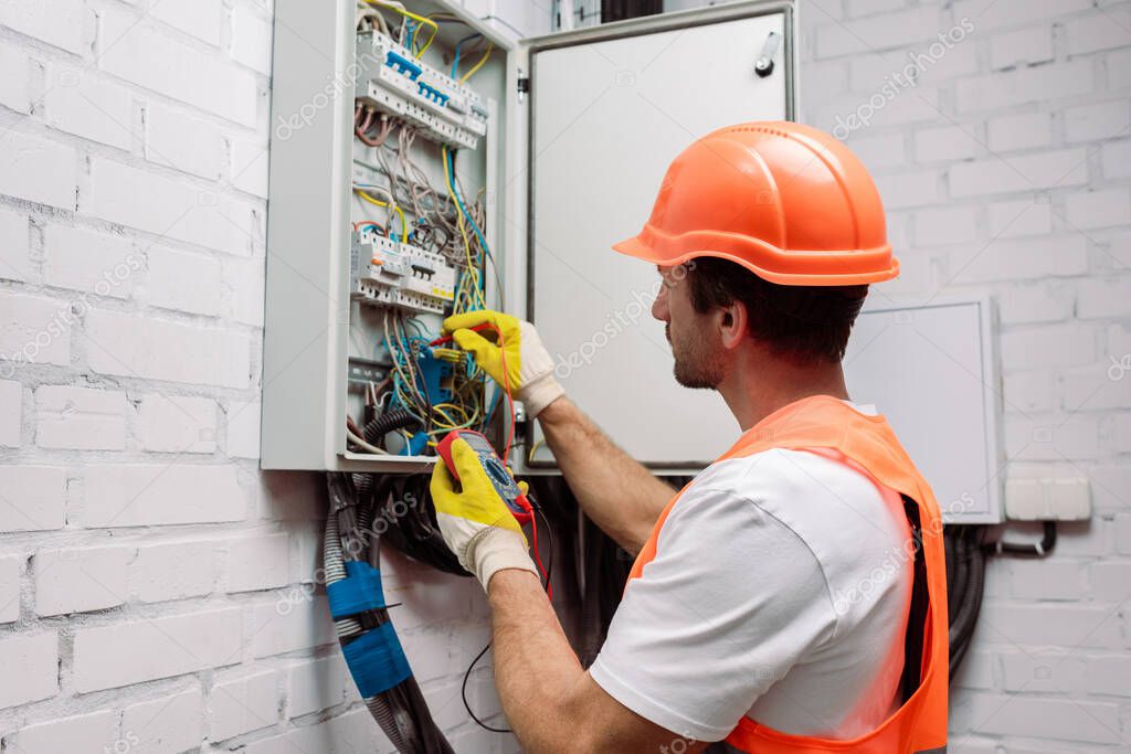 Electrician inspecting an electrical panel
