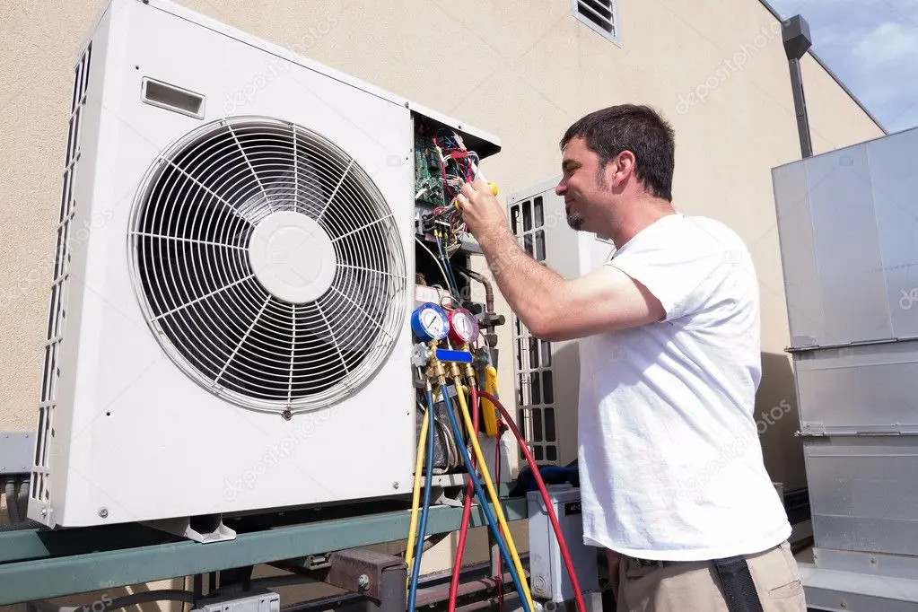 HVAC lead servicing an outdoor condenser