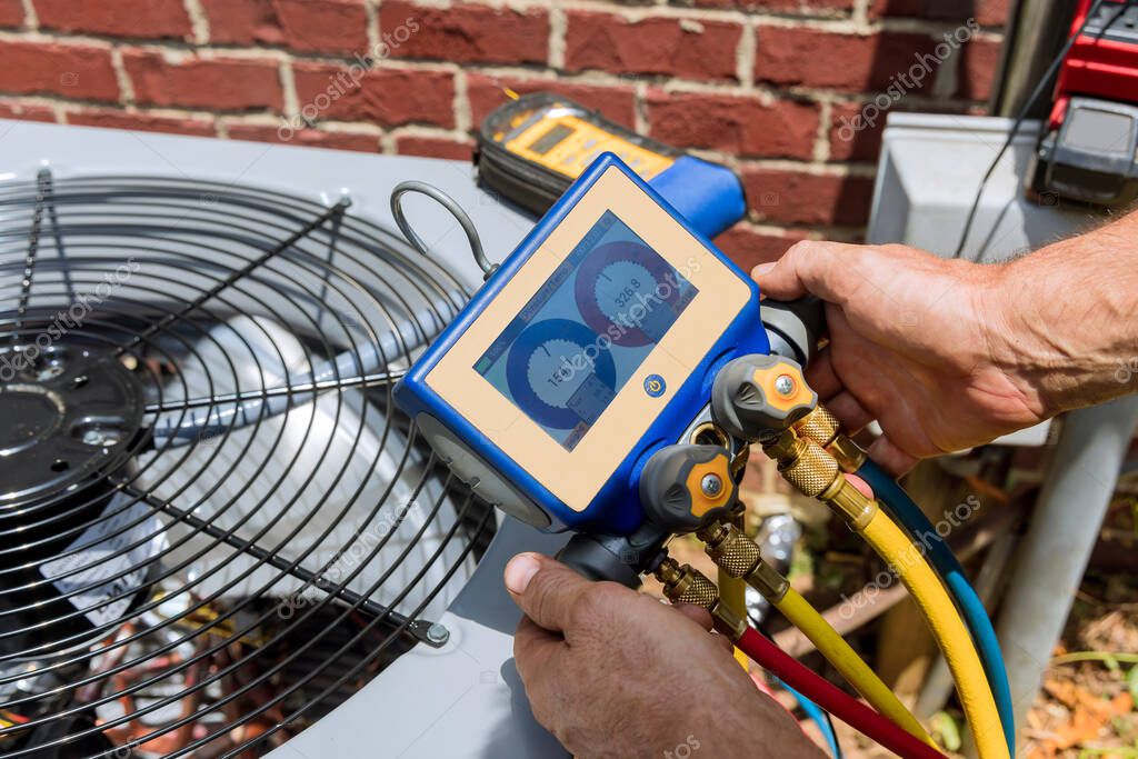 HVAC technician servicing an outdoor condenser